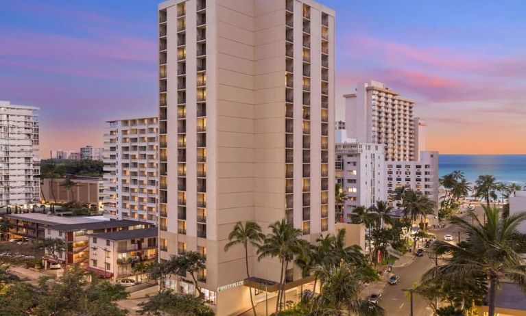 Hotel exterior at sunset at Hyatt Place Waikiki Beach.