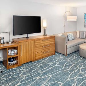 Day room with TV and work space at Hyatt Place Waikiki Beach.