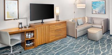 Day room with TV and work space at Hyatt Place Waikiki Beach.