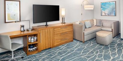 Day room with TV and work space at Hyatt Place Waikiki Beach.