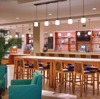 Hotel bar and coworking area at Hyatt Place Waikiki Beach.