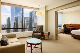 Luxurious king suite with lounge area at Millennium Downtown New York.