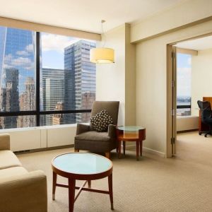 Luxurious king suite with lounge area at Millennium Downtown New York.