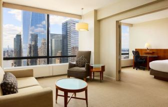 Luxurious king suite with lounge area at Millennium Downtown New York.