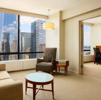 Luxurious king suite with lounge area at Millennium Downtown New York.