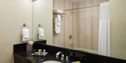 Guest bathroom with shower at Millennium Downtown New York.