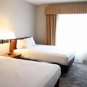 Spacious day room with two queen beds at Country Inn & Suites By Radisson, BWI Airport.