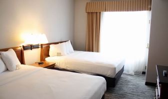 Spacious day room with two queen beds at Country Inn & Suites By Radisson, BWI Airport.