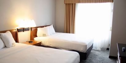 Spacious day room with two queen beds at Country Inn & Suites By Radisson, BWI Airport.