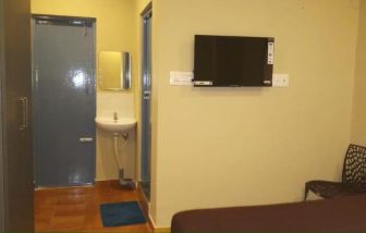 Day room with TV and private bathroom at The Nisarga Residency.