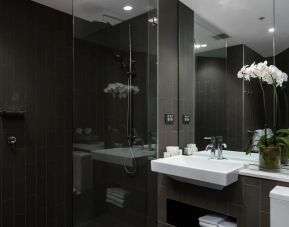 Guest bathroom with shower at Rydges Sydney Airport Hotel.