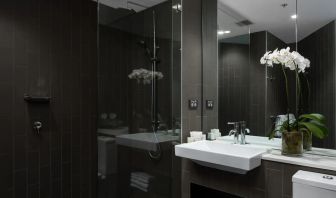 Guest bathroom with shower at Rydges Sydney Airport Hotel.