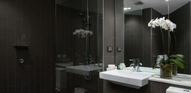 Guest bathroom with shower at Rydges Sydney Airport Hotel.