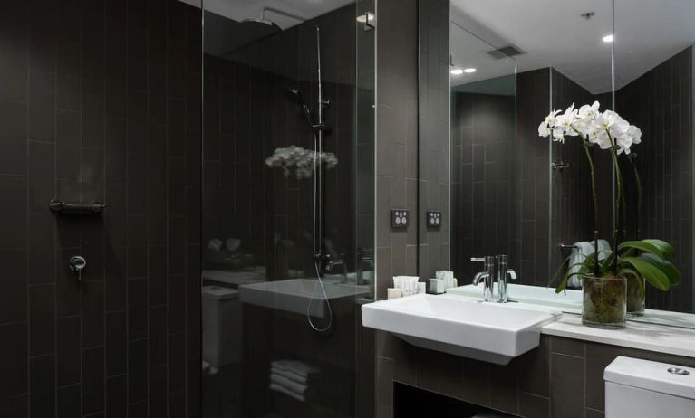 Guest bathroom with shower at Rydges Sydney Airport Hotel.