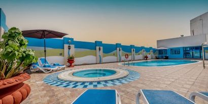 Outdoor pool with loungers at The Park Hotel.