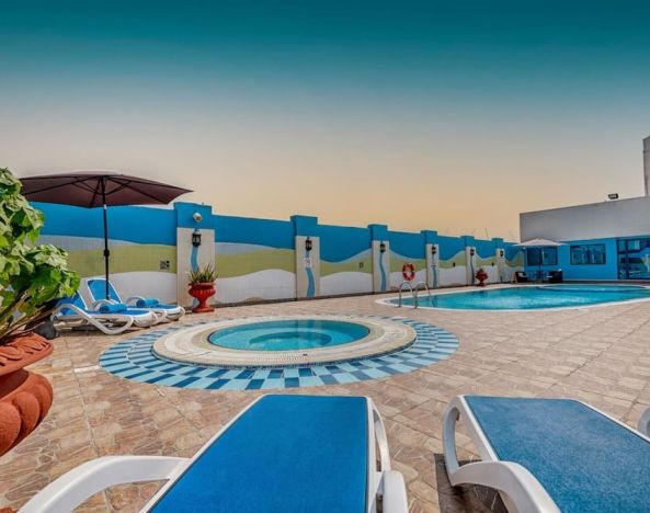 Outdoor pool with loungers at The Park Hotel.