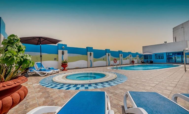 Outdoor pool with loungers at The Park Hotel.