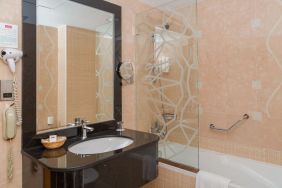 Guest bathroom with bath and shower at The Park Hotel.