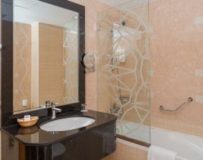 Guest bathroom with bath and shower at The Park Hotel.