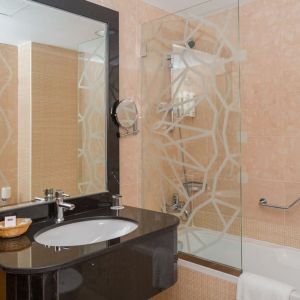 Guest bathroom with bath and shower at The Park Hotel.