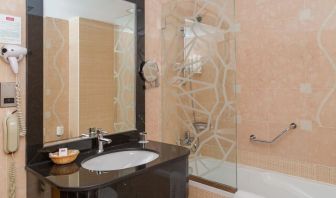 Guest bathroom with bath and shower at The Park Hotel.