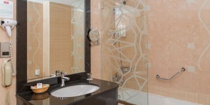 Guest bathroom with bath and shower at The Park Hotel.