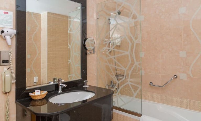 Guest bathroom with bath and shower at The Park Hotel.