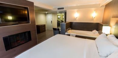 Cozy king room with TV and hot tub at Holiday Inn Express Edmonton Downtown.