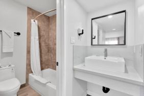 Guest bathroom with shower at Tradewinds Motel.