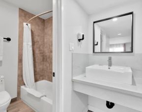 Guest bathroom with shower at Tradewinds Motel.