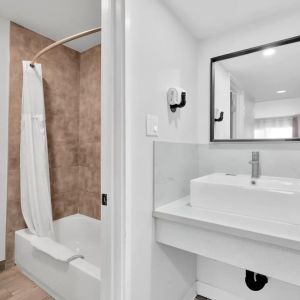 Guest bathroom with shower at Tradewinds Motel.