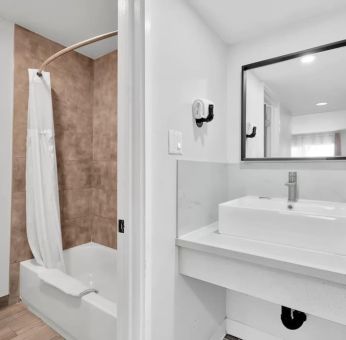 Guest bathroom with shower at Tradewinds Motel.