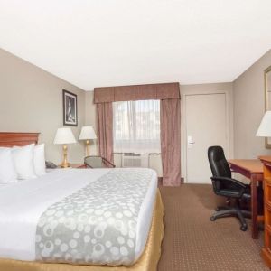 Day use room with TV and work desk at Days Inn By Wyndham St Augustine/Historic Downtown.