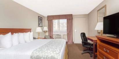 Day use room with TV and work desk at Days Inn By Wyndham St Augustine/Historic Downtown.