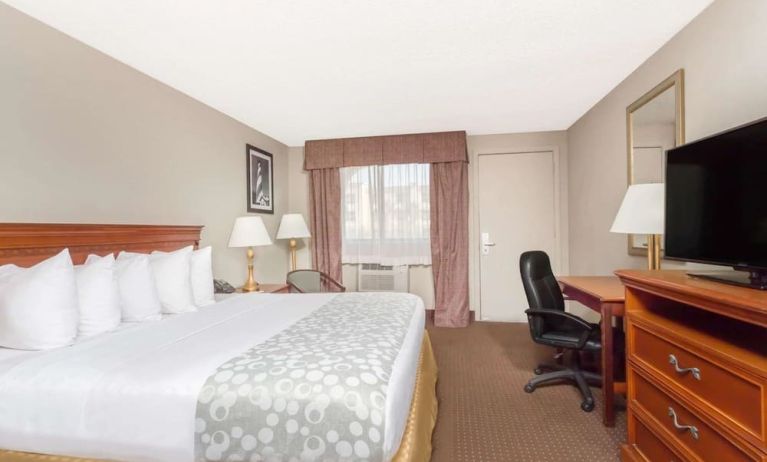 Day use room with TV and work desk at Days Inn By Wyndham St Augustine/Historic Downtown.