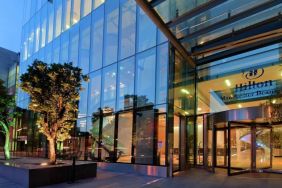 Hotel exterior at night at Hilton Manchester Deansgate.