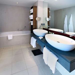 Guest bathroom with shower and bath at Hilton Manchester Deansgate.