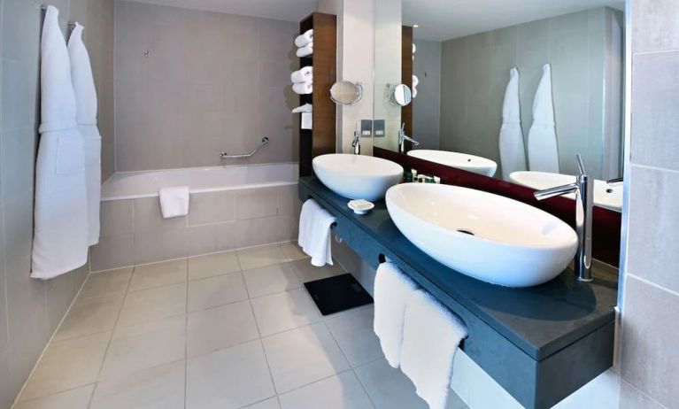 Guest bathroom with shower and bath at Hilton Manchester Deansgate.