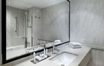 Guest bathroom with shower at DoubleTree By Hilton Woking.