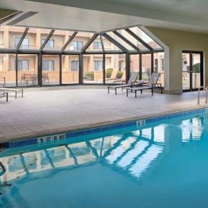 Sonesta Select Indianapolis Carmel’s indoor pool has loungers and chairs nearby.