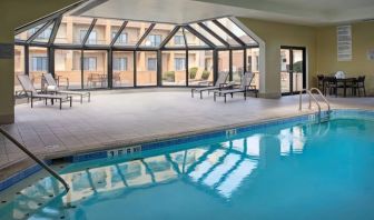 Sonesta Select Indianapolis Carmel’s indoor pool has loungers and chairs nearby.