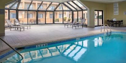 Sonesta Select Indianapolis Carmel’s indoor pool has loungers and chairs nearby.