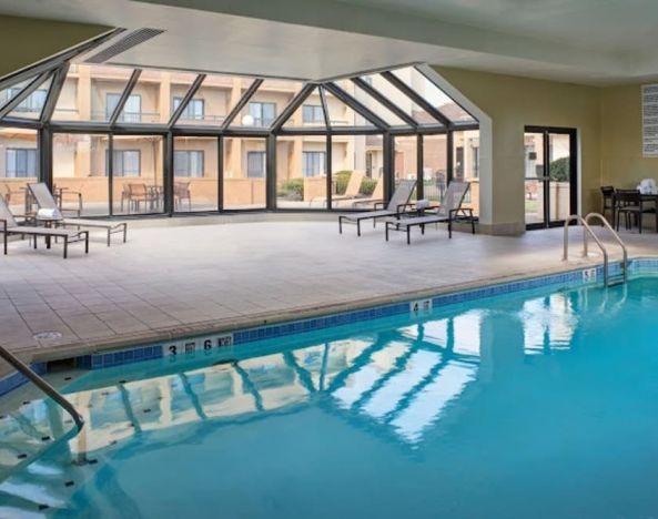 Sonesta Select Indianapolis Carmel’s indoor pool has loungers and chairs nearby.