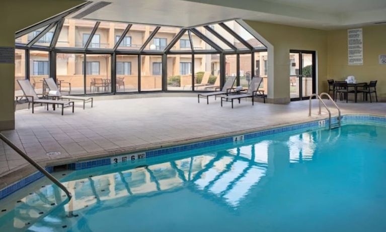 Sonesta Select Indianapolis Carmel’s indoor pool has loungers and chairs nearby.