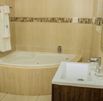 Guest bathroom with tub at Heavenly Boutique Guesthouse. 