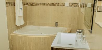 Guest bathroom with tub at Heavenly Boutique Guesthouse. 