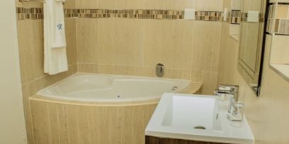 Guest bathroom with tub at Heavenly Boutique Guesthouse. 