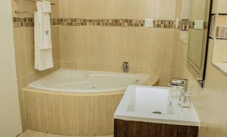 Guest bathroom with tub at Heavenly Boutique Guesthouse. 