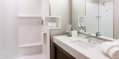 Guest bathroom with shower at Courtyard By Marriott Houston North/ Shenandoah.  