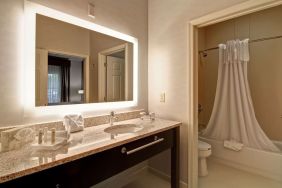 Guest bathroom with shower and tub at Homewood Suites By Hilton Newark-Cranford.